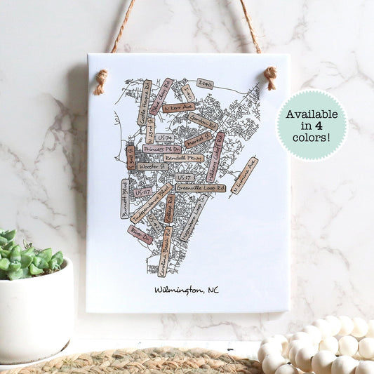 A street map drawing of Wilmington NC on a rectangle tile sign hanging on a wall - Sparks House Co