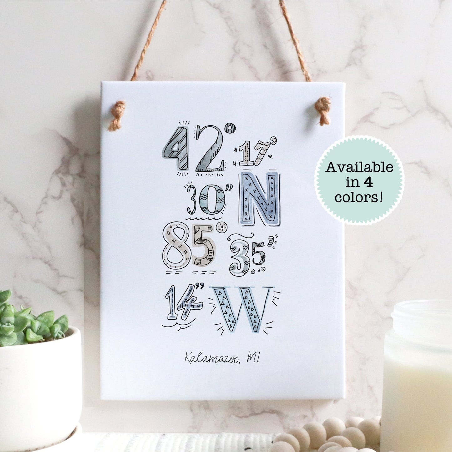 A city drawing of the coordinates of Kalamazoo MI on a rectangle tile sign, hanging on a wall - Sparks House Co