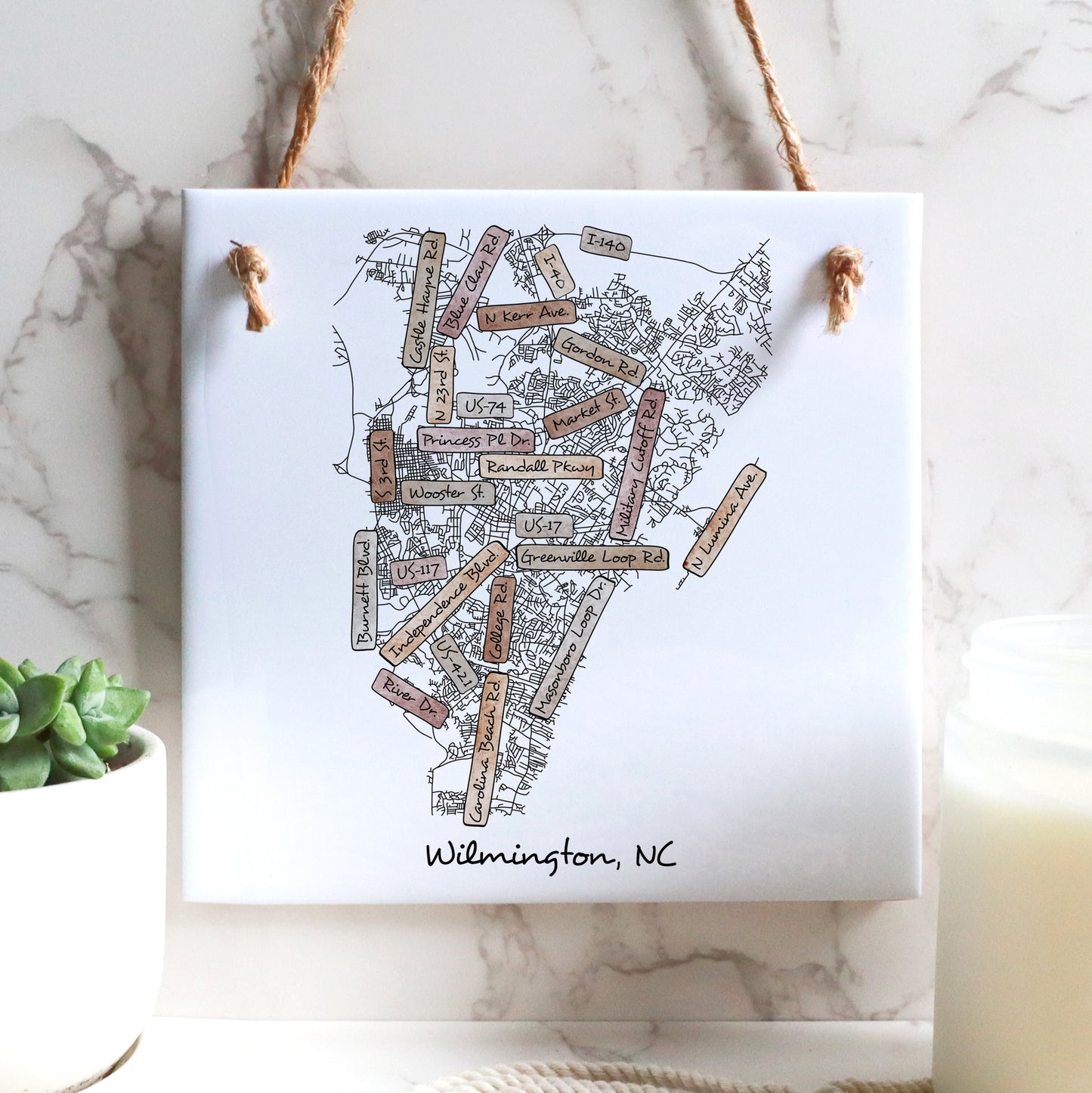 A street map of Wilmington North Carolina on a ceramic square tile sign hanging on a wall - in the color boho