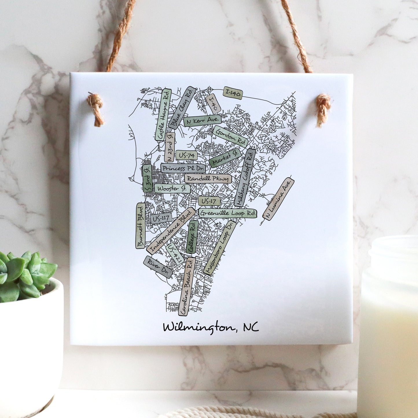 A street map of Wilmington North Carolina on a ceramic square tile sign hanging on a wall - in the color earthy