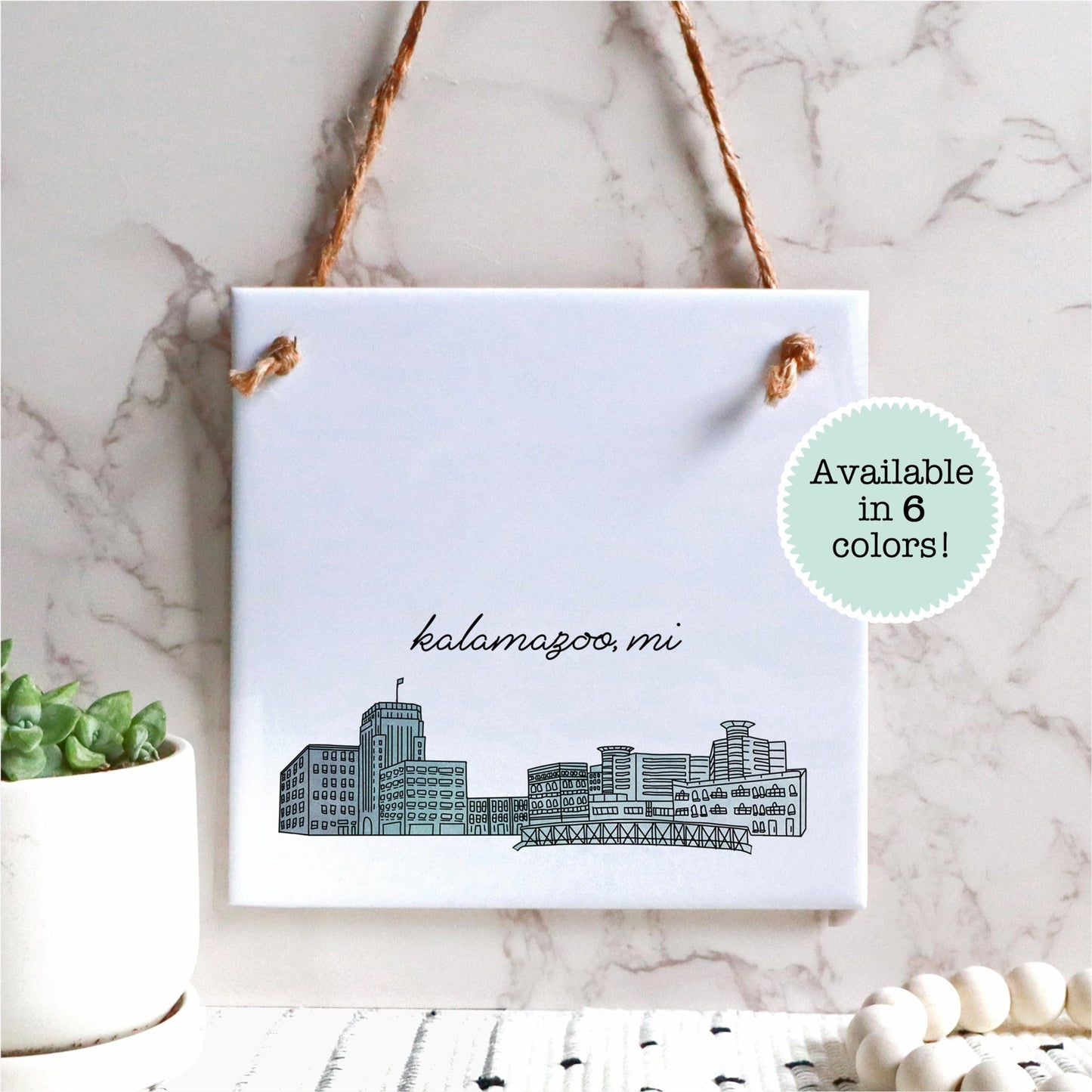 A hand drawn city drawing of Wilmington NC, on ceramic square tile sign, hanging on a wall - in the color blue