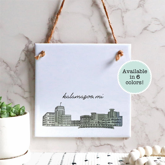 A hand drawn city drawing of Kalamazoo Michigan, on ceramic square tile sign, hanging on a wall - Sparks House Co