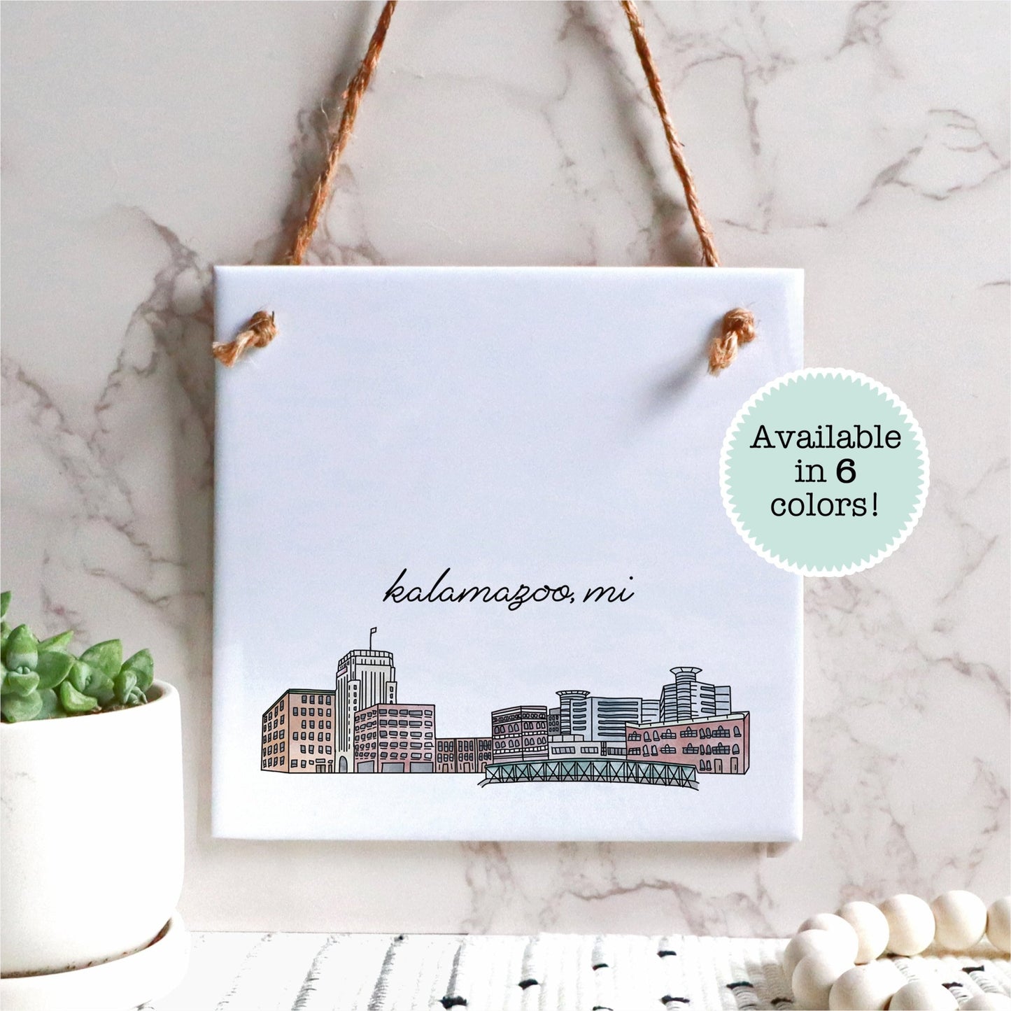 A hand drawn city drawing of Wilmington NC, on ceramic square tile sign, hanging on a wall - in the color natural
