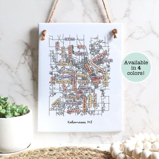 A street map drawing of Kalamazoo MI on a rectangle tile sign hanging on a wall - Sparks House Co