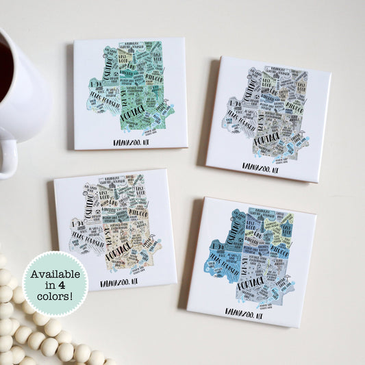 A hand drawn map of Kalamazoo MI on a set of 4 ceramic coasters, sitting on a table - in 4 colors - Sparks House Co