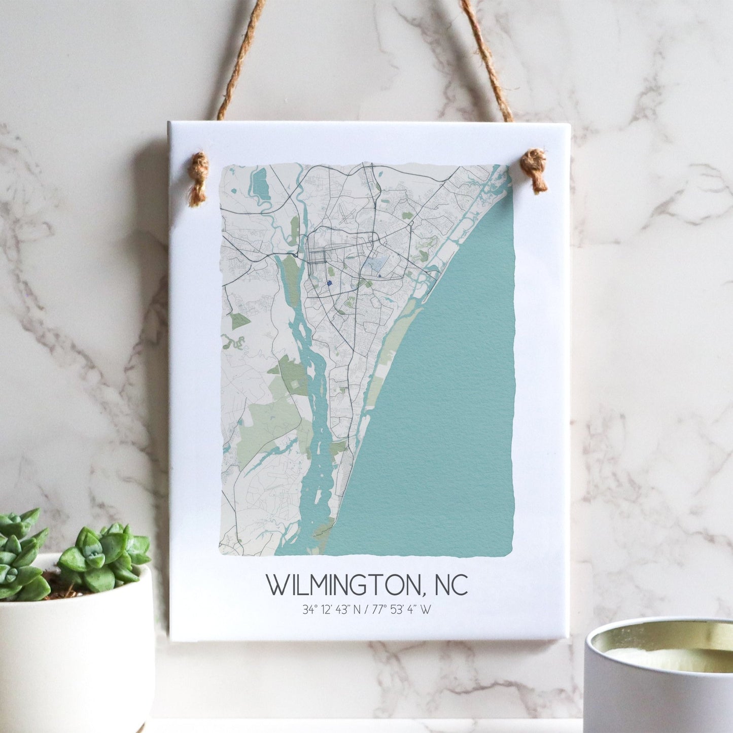 A Wilmington NC city map on a ceramic rectangle tile sign hanging on a wall, in beige