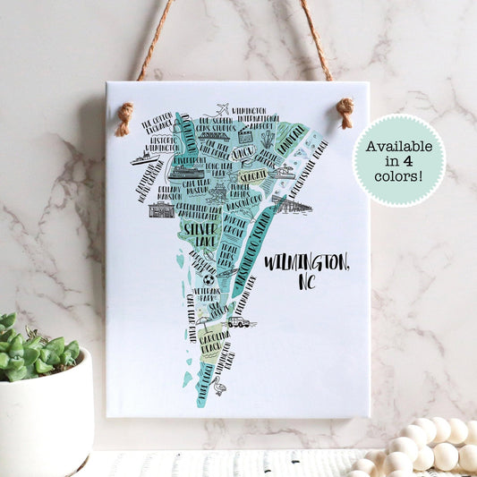 An illustrated map of Wilmington NC on a rectangle tile sign, hanging on a wall - Sparks House Co